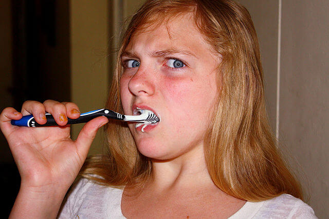aggresive brushing teeth